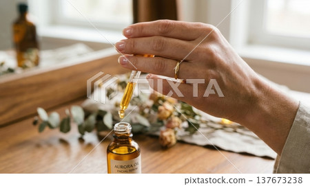 Golden Argan Hair Oil Drop from Glass Pipette Macro Shot Golden Argan Hair Oil Drop from Glass Pipette Macro Shot 137673238