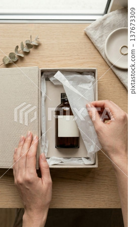 Hands Lifting Delicate Tissue Paper in Luxury Box Reveal Hands Lifting Delicate Tissue Paper in Luxury Box Reveal 137673309