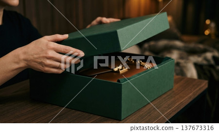 Close Up of Hands Lifting Lid of Premium Forest Green Box Close Up of Hands Lifting Lid of Premium Forest Green Box 137673316