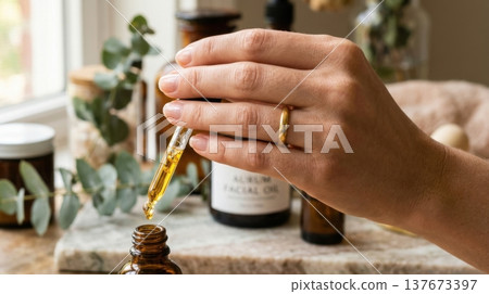 Golden Argan Hair Oil Drop from Glass Pipette Macro Shot 137673397