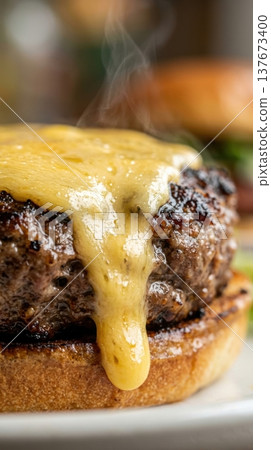 Extreme Macro of Melted Cheddar Cheese Dripping Down Burger Patty 137673400