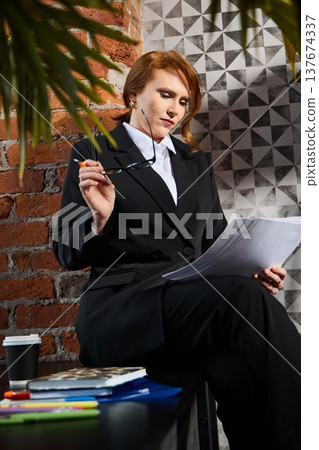 Professional overseeing remote call with urban loft background 137674337