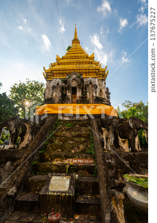 Wat Chiang Man in Chiang Mai Thailand at sunset with its iconic elephant encircled golden stupa and historic Lanna architecture, a must see cultural and travel destination. 137675227