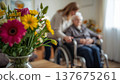 A daughter wishes her wheelchair-bound mother a Happy Mother's Day. An elderly woman in a wheelchair at home. Conceptual themes of healthcare, aging, home care, and Mother's Day greetings. 137675261