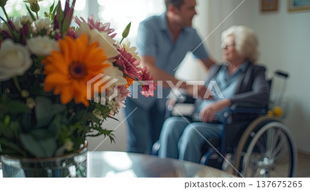 A daughter wishes her wheelchair-bound mother a Happy Mother's Day. An elderly woman in a wheelchair at home. Conceptual themes of healthcare, aging, home care, and Mother's Day greetings. A daughter wishes her wheelchair-bound mother a Happy Mother's Day. An elderly woman in a wheelchair at home. Conceptual themes of healthcare, aging, home care, and Mother's Day greetings. 137675265