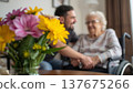 A daughter wishes her wheelchair-bound mother a Happy Mother's Day. An elderly woman in a wheelchair at home. Conceptual themes of healthcare, aging, home care, and Mother's Day greetings. 137675266