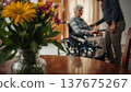 A daughter wishes her wheelchair-bound mother a Happy Mother's Day. An elderly woman in a wheelchair at home. Conceptual themes of healthcare, aging, home care, and Mother's Day greetings. 137675267