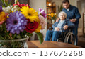 A daughter wishes her wheelchair-bound mother a Happy Mother's Day. An elderly woman in a wheelchair at home. Conceptual themes of healthcare, aging, home care, and Mother's Day greetings. 137675268