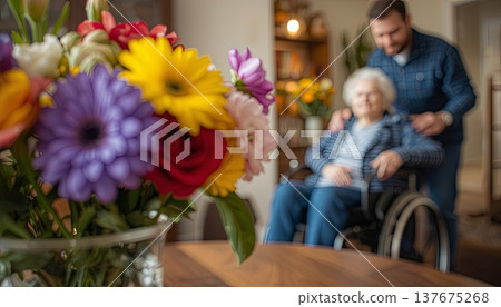 A daughter wishes her wheelchair-bound mother a Happy Mother's Day. An elderly woman in a wheelchair at home. Conceptual themes of healthcare, aging, home care, and Mother's Day greetings. A daughter wishes her wheelchair-bound mother a Happy Mother's Day. An elderly woman in a wheelchair at home. Conceptual themes of healthcare, aging, home care, and Mother's Day greetings. 137675268