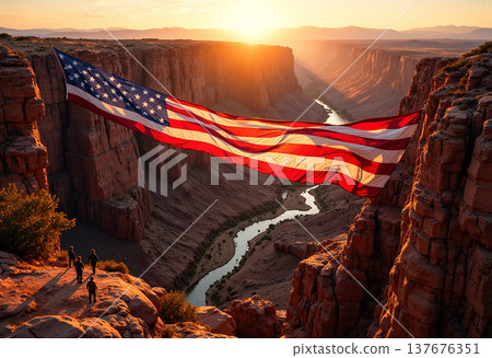 Large american flag hanging across desert canyon 137676351