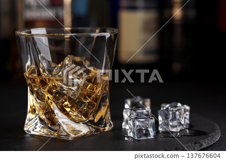 Whiskey Glass with Ice. Sophisticated Bar Ambience 137676604
