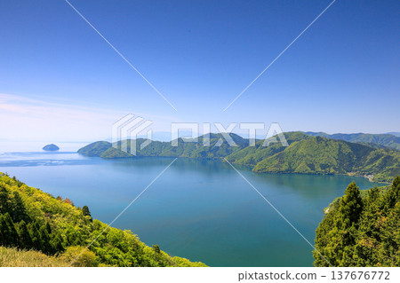 Chikubu Island and Lake Biwa as seen from the lush green Shizugatake Mountains. 137676772