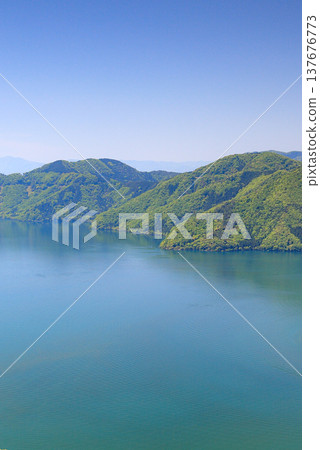 Fresh greenery and the shimmering surface of Lake Biwa in the depths of the lake - vertical Fresh greenery and the shimmering surface of Lake Biwa in the depths of the lake - vertical 137676773