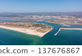 Aerial view of serene beach landscape featuring turquoise waters, sandy shores, and coastal vegetation, perfect for relaxation and leisure activities. Tavira Portugal Algarve 137676867