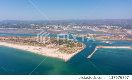 Aerial view of serene beach landscape featuring turquoise waters, sandy shores, and coastal vegetation, perfect for relaxation and leisure activities. Tavira Portugal Algarve Aerial view of serene beach landscape featuring turquoise waters, sandy shores, and coastal vegetation, perfect for relaxation and leisure activities. Tavira Portugal Algarve 137676867