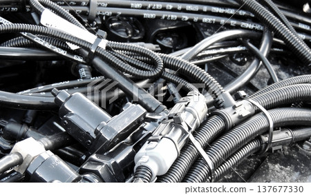 Bundles of coolant tubes, oil pipes, isolation hoses and corrugated wires inside engine Bundles of coolant tubes, oil pipes, isolation hoses and corrugated wires inside engine 137677330