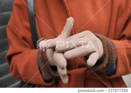 Hands showing a gesture in a cozy outfit outdoors Hands showing a gesture in a cozy outfit outdoors 137677398
