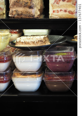 Desserts displayed on shelves in a busy bakery shop Desserts displayed on shelves in a busy bakery shop 137677401