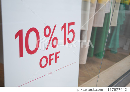 Discount sign offers savings for shoppers in store Discount sign offers savings for shoppers in store 137677442