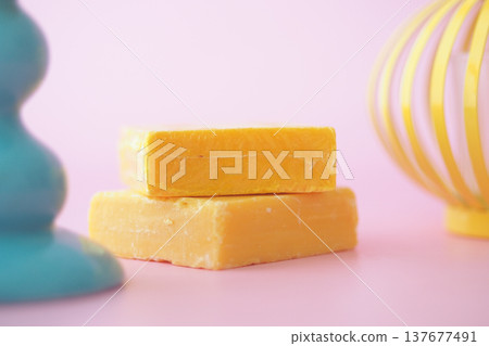 Yellow soap bars on a pink background with a blue stand 137677491