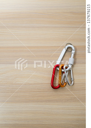 Connecting carabiners and copy space on a wood grain background Connecting carabiners and copy space on a wood grain background 137679215