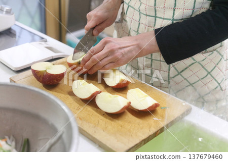Woman cutting an apple Woman cutting an apple 137679460