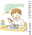 A primary school boy eating his lunch in the classroom. 137679551