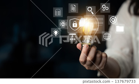 Creative visual representation of ideas and innovation, showcasing a light bulb surrounded by digital icons for technology and data visualization concepts Gantry 137679733