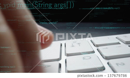 Close-up of a Hand Typing Code on a Computer Keyboard with Programming Text and Digital Data Illustrating Software Development Concept xenic 137679786