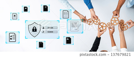 Collaborative Approach to Data Security with Hands Holding Gears and Digital Elements on a White Table Quark 137679821