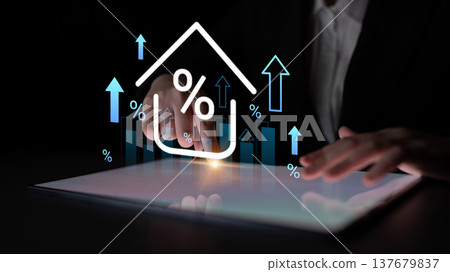 Hands on a tablet showing upward trends with percentage symbols and house icon representing real estate market growth and financial investment analysis Gantry Hands on a tablet showing upward trends with percentage symbols and house icon representing real estate market growth and financial investment analysis Gantry 137679837