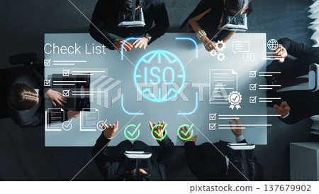 Modern Business Meeting on ISO Certification with Team Collaborating Over Checklist and Important Documents in Office Environment Gluon 137679902