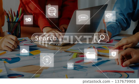 Collaborative Office Environment with Laptop, Search Bar Overlay, and Graphic Designs on Table Highlighting Teamwork and Creativity in Business. Raster Collaborative Office Environment with Laptop, Search Bar Overlay, and Graphic Designs on Table Highlighting Teamwork and Creativity in Business. Raster 137679908