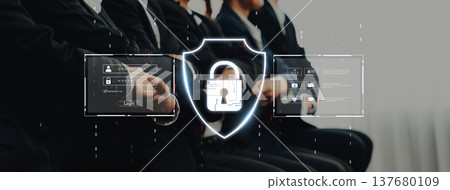Professional business people in suits with a focus on cybersecurity concepts featuring a shield symbol and digital interface elements in a modern setting Trope 137680109