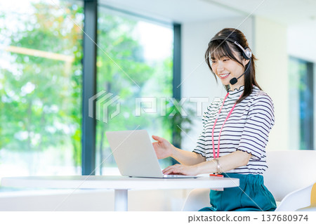 Young woman working in a call center 137680974