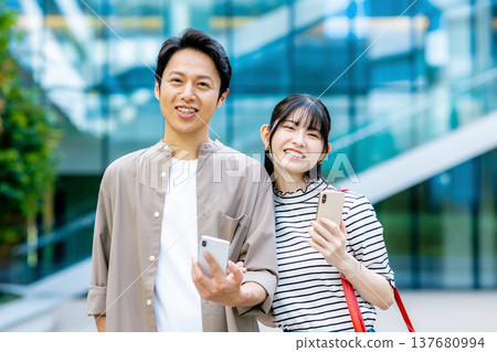 A couple looking at a smartphone A couple looking at a smartphone 137680994