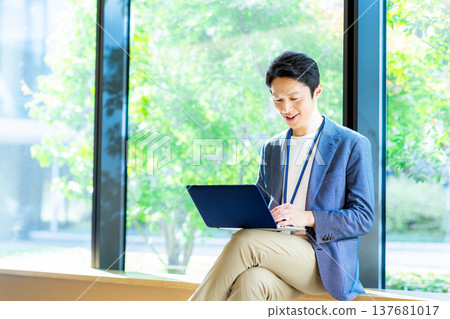 A businessman with a laptop computer A businessman with a laptop computer 137681017