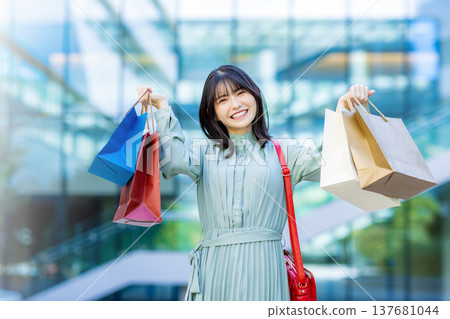 A woman with a shopping bag A woman with a shopping bag 137681044