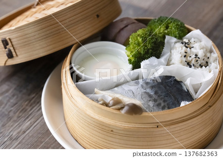 Steamed breakfast in a bamboo steamer; photographed in natural light. Steamed breakfast in a bamboo steamer; photographed in natural light. 137682363