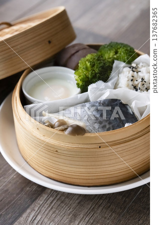 Steamed breakfast in a bamboo steamer; photographed in natural light. 137682365