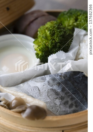 Steamed breakfast in a bamboo steamer; photographed in natural light. 137682366