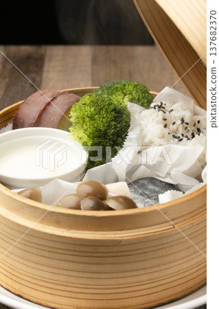 Steamed breakfast in a bamboo steamer Steamed breakfast in a bamboo steamer 137682370
