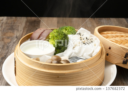 Steamed breakfast in a bamboo steamer Steamed breakfast in a bamboo steamer 137682372