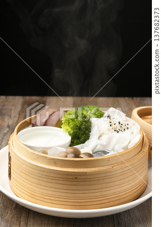 Steamed breakfast in a bamboo steamer Steamed breakfast in a bamboo steamer 137682373