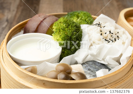 Steamed breakfast in a bamboo steamer Steamed breakfast in a bamboo steamer 137682376