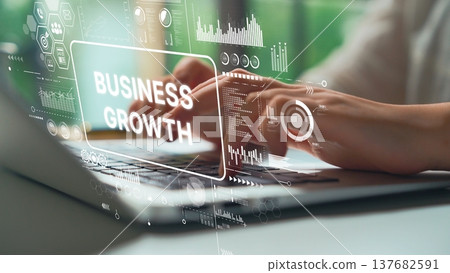 Hands Typing on Laptop with Business Growth Charts and Data Analysis Visuals in Modern Office Environment. Asymptotic smart data analytic Hands Typing on Laptop with Business Growth Charts and Data Analysis Visuals in Modern Office Environment. Asymptotic smart data analytic 137682591