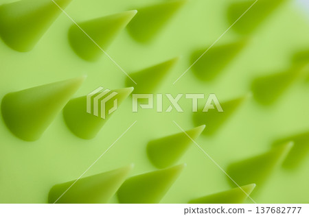 A macro shot of green conical silicone bristles on a scalp massager or cleaning brush A macro shot of green conical silicone bristles on a scalp massager or cleaning brush 137682777