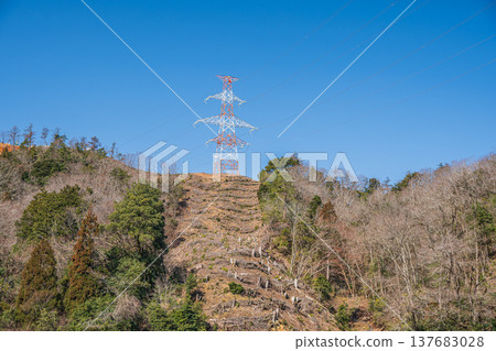A power transmission tower standing on a mountaintop in Omi-Shiotsu, Nagahama City, Shiga Prefecture A power transmission tower standing on a mountaintop in Omi-Shiotsu, Nagahama City, Shiga Prefecture 137683028