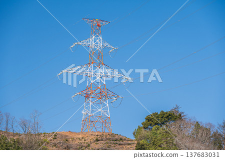 A power transmission tower standing on a mountaintop in Omi-Shiotsu, Nagahama City, Shiga Prefecture 137683031