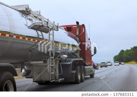 Large tanker truck travels on highway with cars moving in opposite direction 137683311